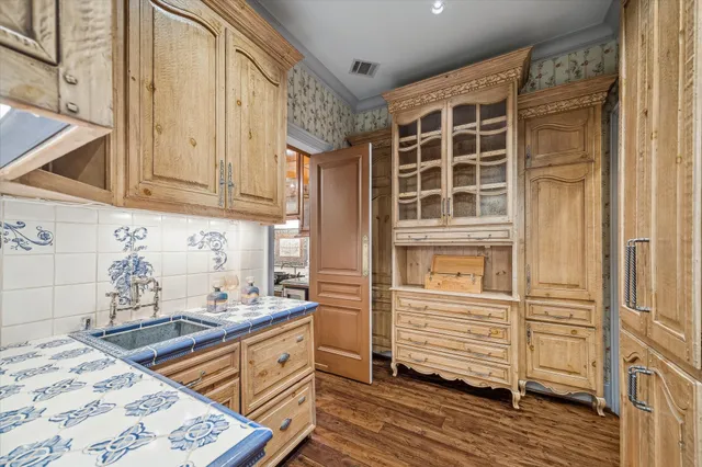 a kitchen with granite countertop wooden cabinets and a stove