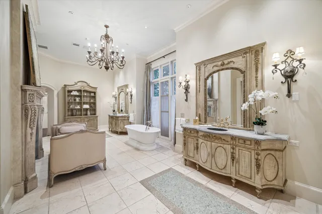a living room with furniture a chandelier and fireplace