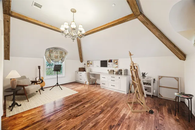 a spacious bedroom with a bed and a flat screen tv