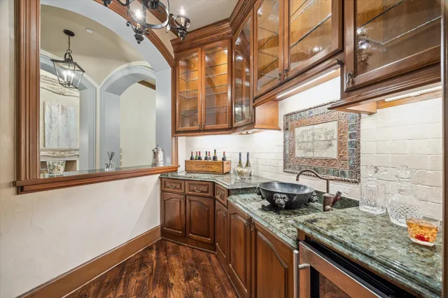 a kitchen with stainless steel appliances granite countertop a sink a stove and cabinets