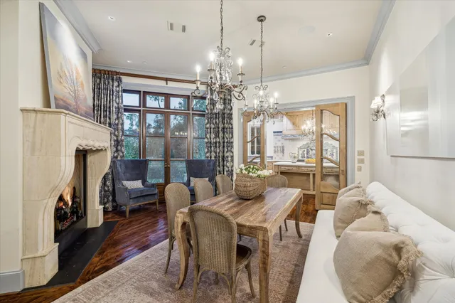 a view of a dining room with furniture a chandelier and wooden floor