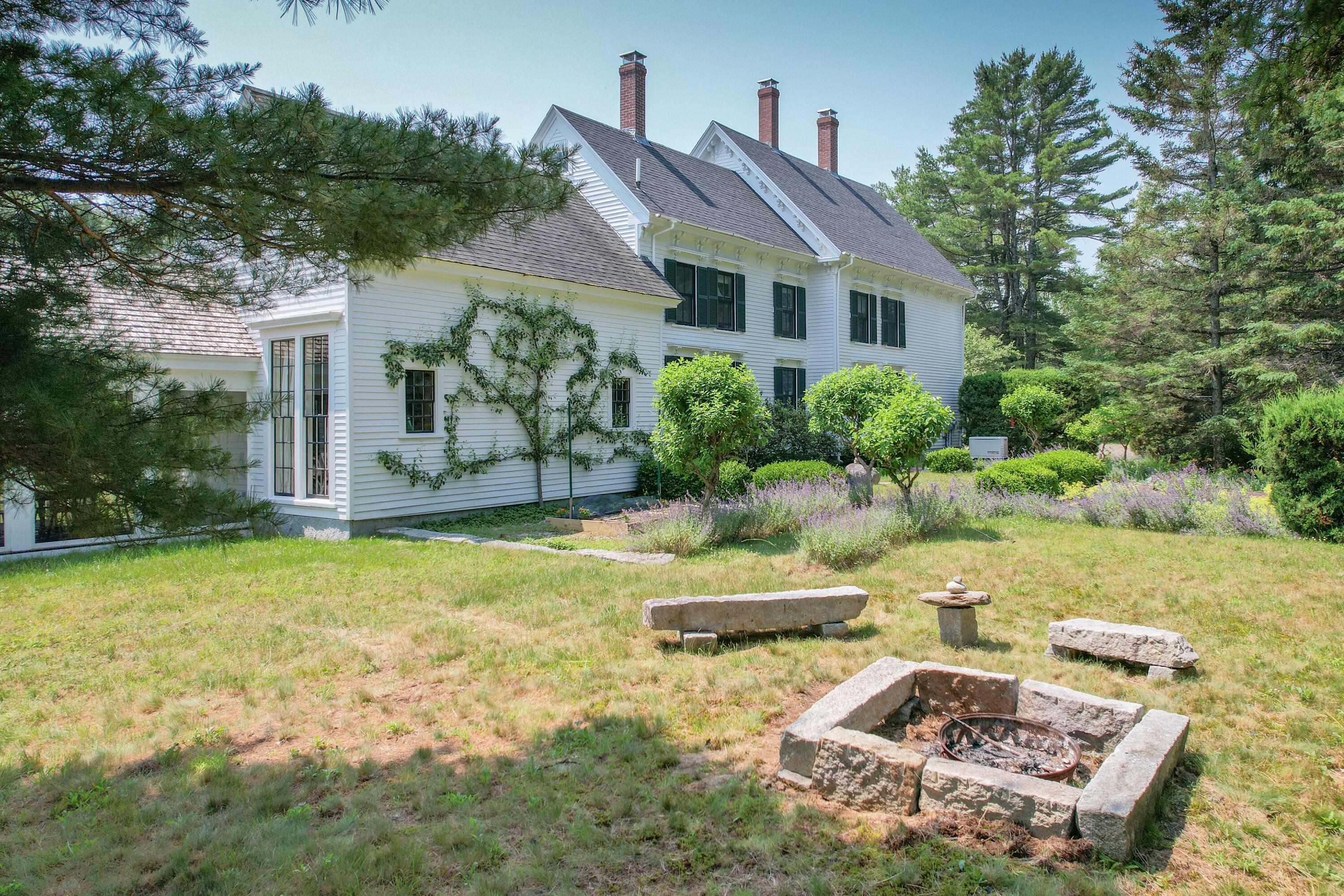 384 Point Road Hancock, ME 04640 - Photo 58 of 70 Granite fire pit with stone seats.