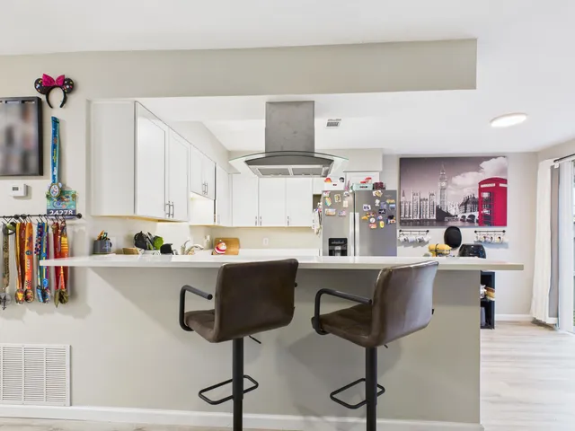 a kitchen with stainless steel appliances a sink and cabinets