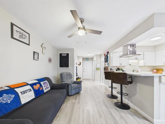 a living room with furniture and wooden floor