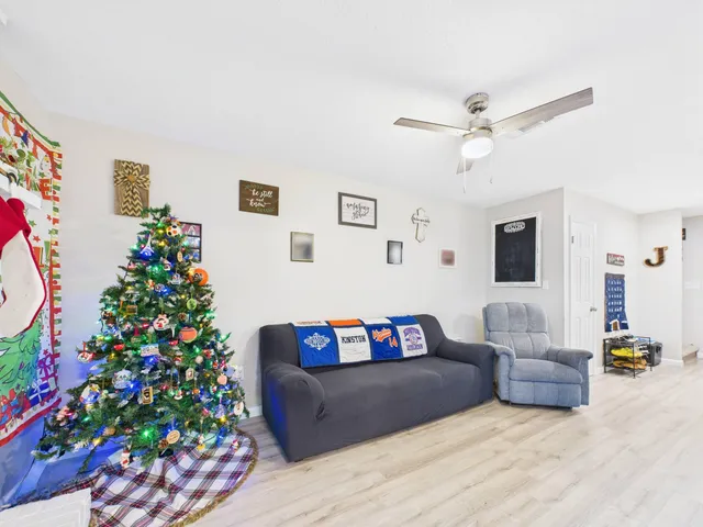 a living room with furniture and a christmas tree