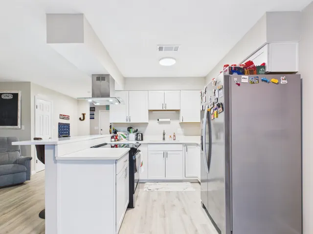 a kitchen with cabinets and stainless steel appliances