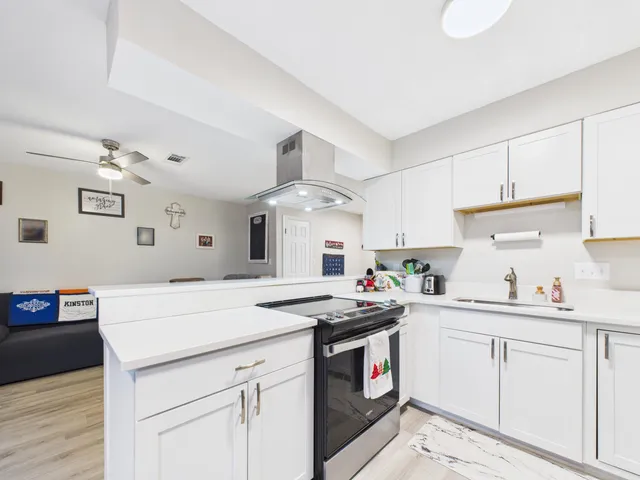 a kitchen with a sink stove and cabinets
