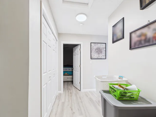 a view of hallway with furniture and a potted plant