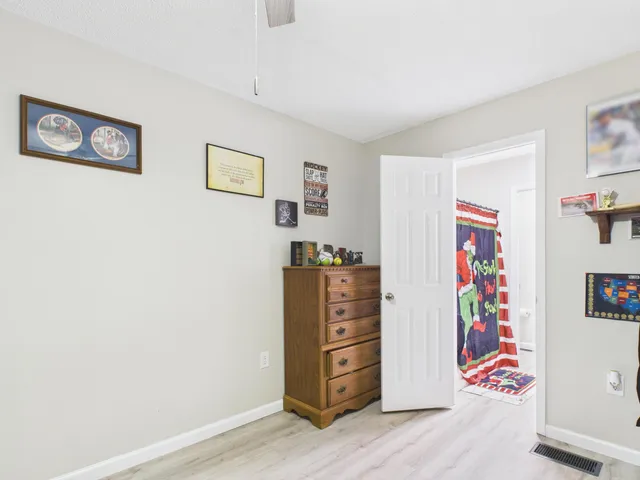 a view of a bedroom with painting on the wall