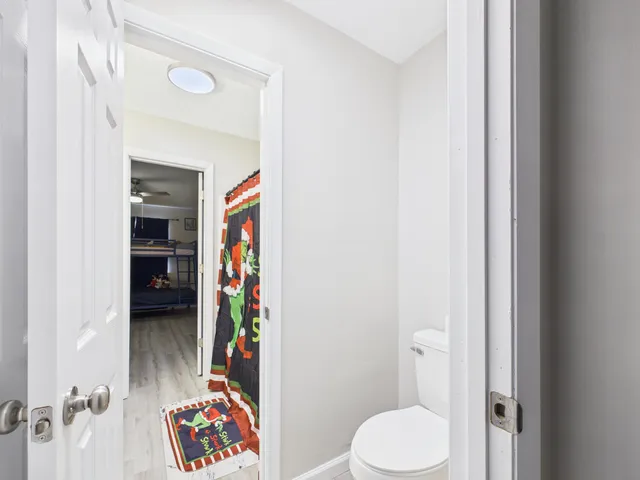 a bathroom with a toilet and a shower curtain
