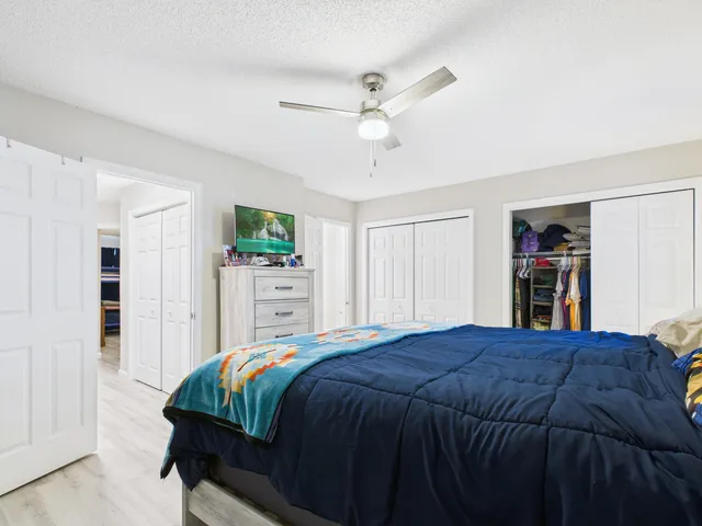 a bedroom with a large bed and a closet