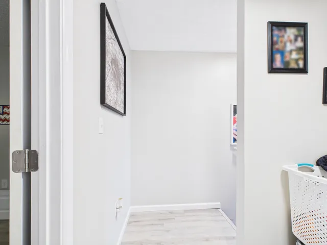 a view of hallway with paintings on the wall