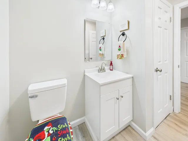 a bathroom with a sink vanity mirror and toilet