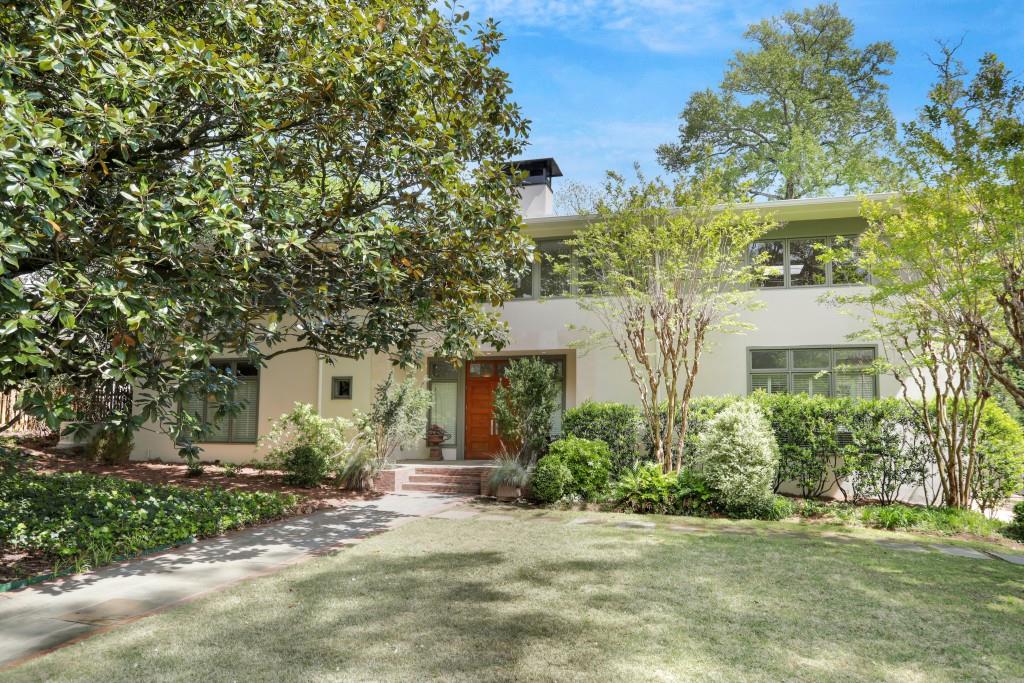 a front view of a house with a garden