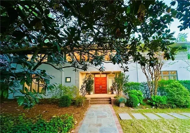 a front view of a house with garden