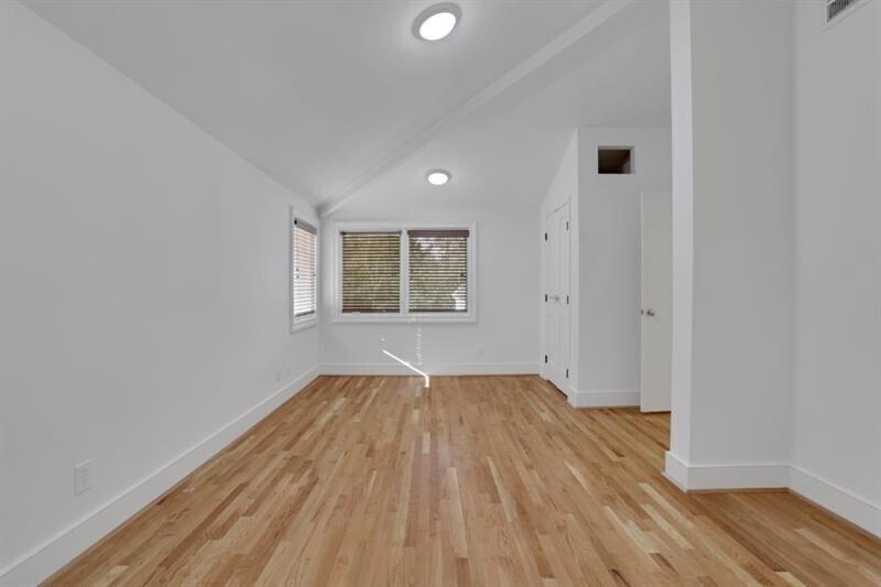 1211 Oakdale Road Northeast Atlanta, GA 30307 - Photo 37 of 67 an empty room with wooden floor and windows