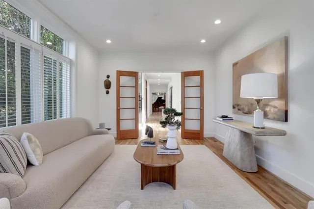 a bedroom with a bed and a painting on the wall