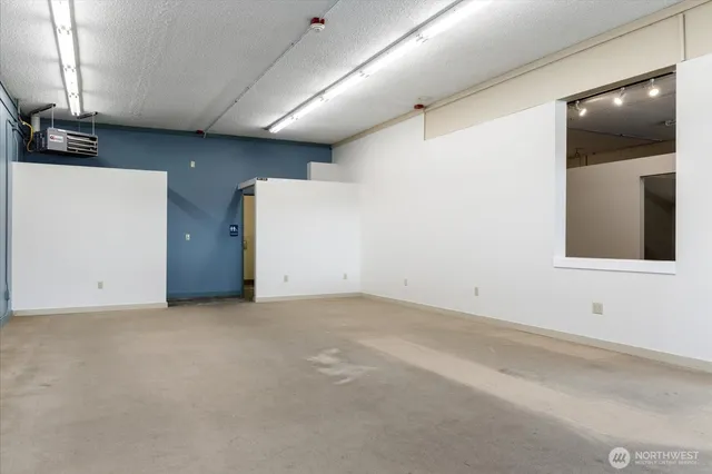 an empty room with a fireplace and cabinet