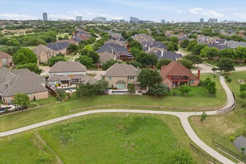 an aerial view of residential houses with outdoor space and swimming pool
