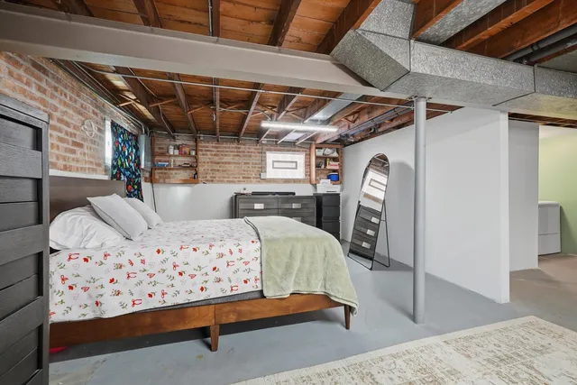 a bed room with a bed chair and a window