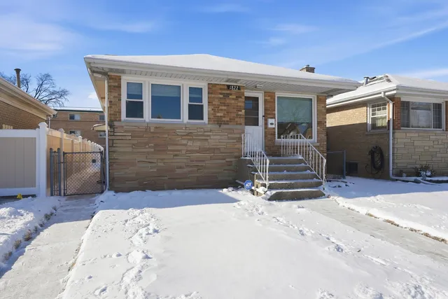 a view of a house with a snow in the background
