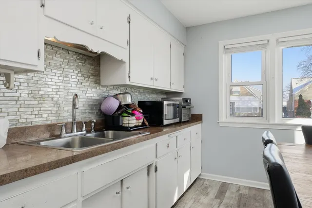 a kitchen with stainless steel appliances granite countertop a sink a stove and cabinets