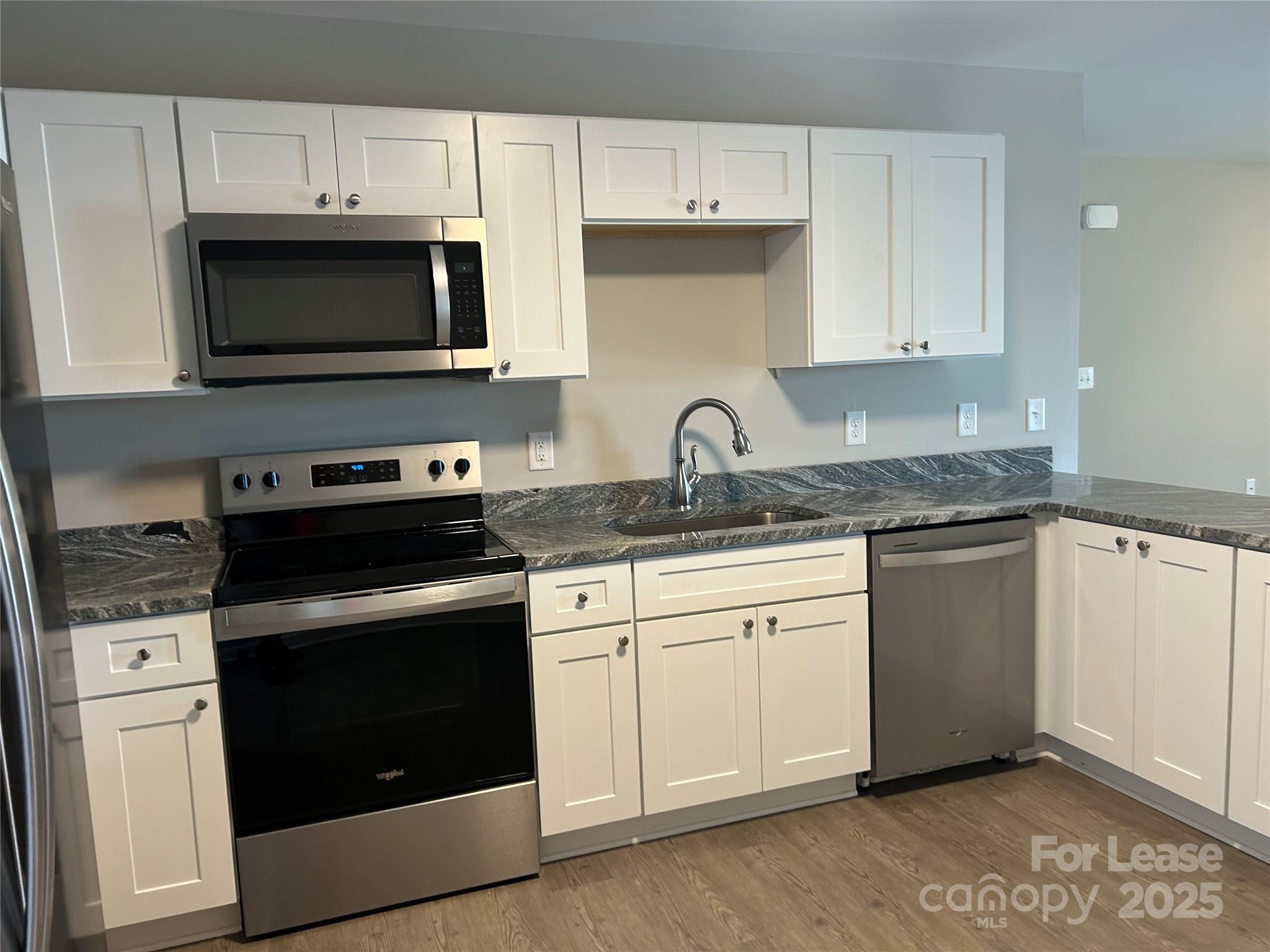 3299 Paul Elmore Road Lincolnton, NC 28092 - Photo 4 of 14 a kitchen with white cabinets and stainless steel appliances