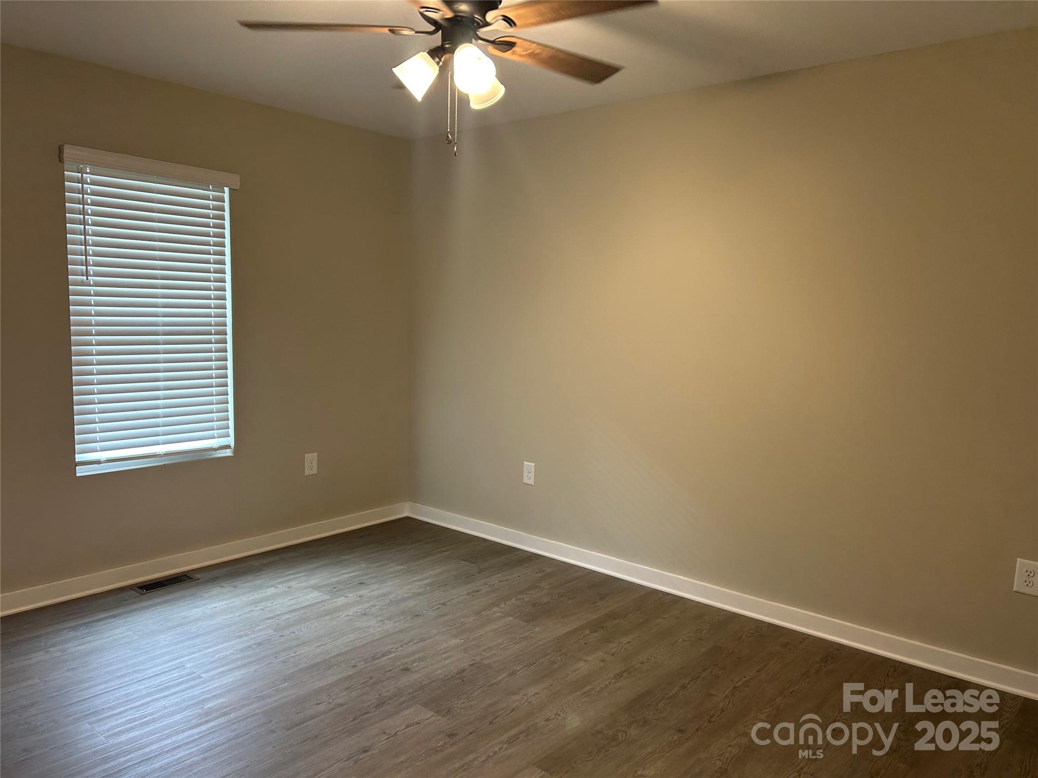 3299 Paul Elmore Road Lincolnton, NC 28092 - Photo 7 of 14 an empty room with wooden floor and windows