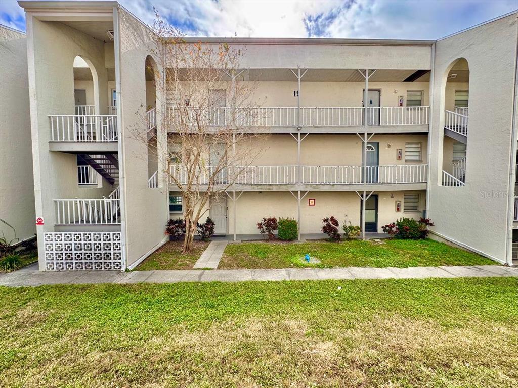 2625 Highway 590, Unit 1932 Clearwater, FL 33759 - Photo 1 of 14 a view of a house with backyard and sitting area