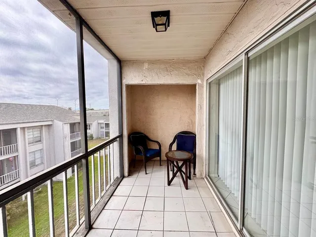a view of a chairs and table in a balcony
