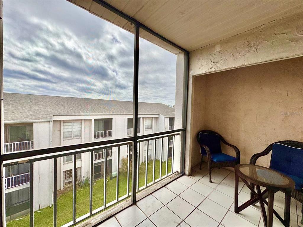 2625 Highway 590, Unit 1932 Clearwater, FL 33759 - Photo 12 of 14 a view of a chairs and table in a balcony