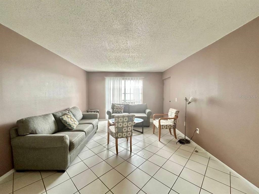 2625 Highway 590, Unit 1932 Clearwater, FL 33759 - Photo 3 of 14 a living room with furniture and window