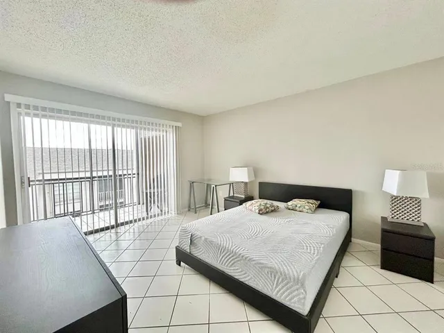 a bedroom with a bed and a large window