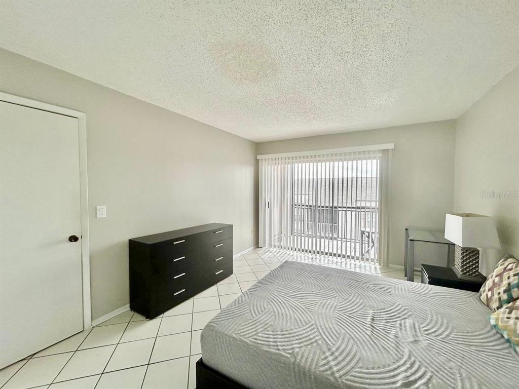 2625 Highway 590, Unit 1932 Clearwater, FL 33759 - Photo 7 of 14 a bedroom with a bed and a tv