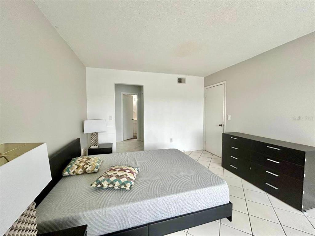 2625 Highway 590, Unit 1932 Clearwater, FL 33759 - Photo 8 of 14 a bedroom with a bed and a night stand