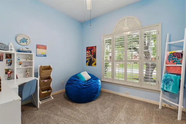 a living room with furniture a flat screen tv and a window