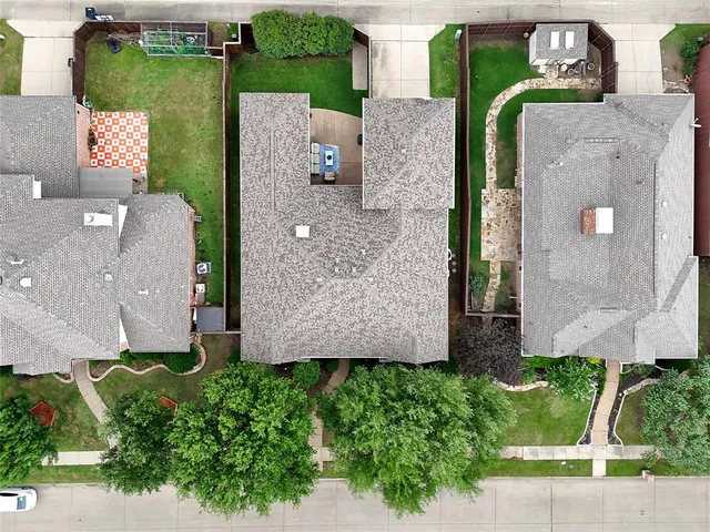 an aerial view of a house with garden space and street view