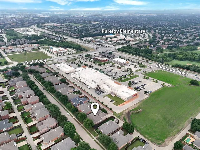 an aerial view of multiple houses with a yard