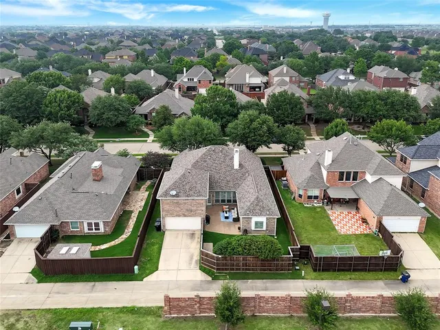 an aerial view of a house with a yard