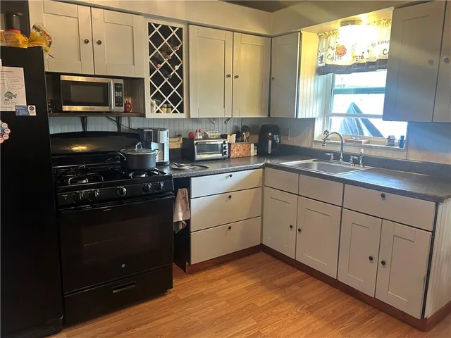 a view of balcony with wooden floor and seating space