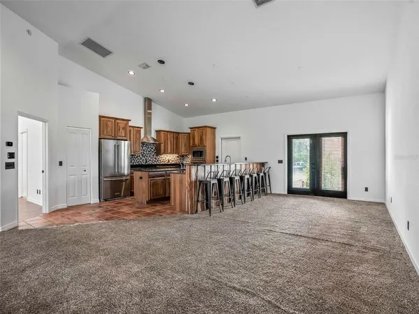 a view of a kitchen with stainless steel appliances granite countertop a stove and a refrigerator