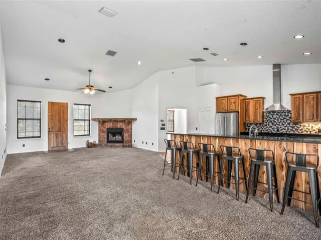 a kitchen with stainless steel appliances granite countertop a refrigerator and a sink