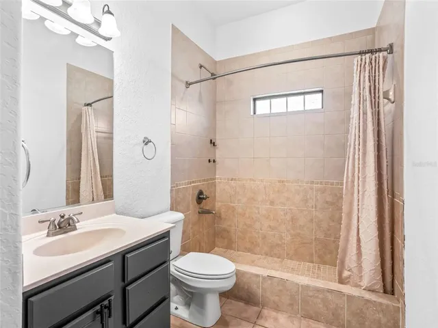 a view of a house with a yard and sitting area