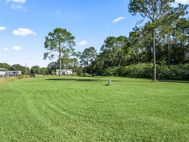 a view of a yard with an outdoor seating
