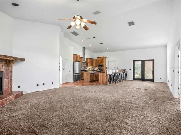 a view of a livingroom with a chandelier furniture and windows