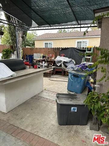 a view of a patio with table and chairs potted plants