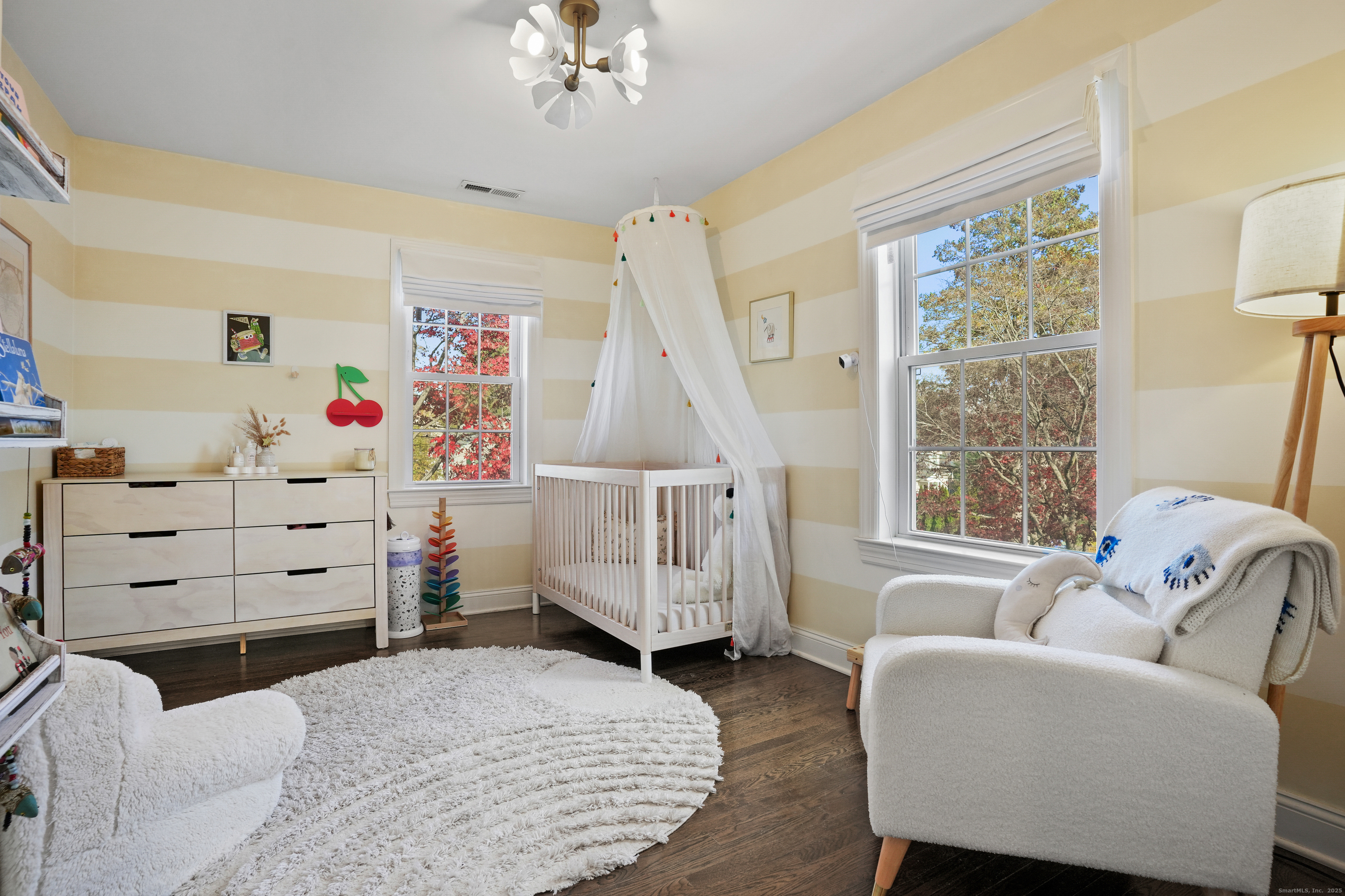 100 Hirsch Road Stamford, CT 06905 - Photo 24 of 39 a bedroom with a baby bed a couch and dresser