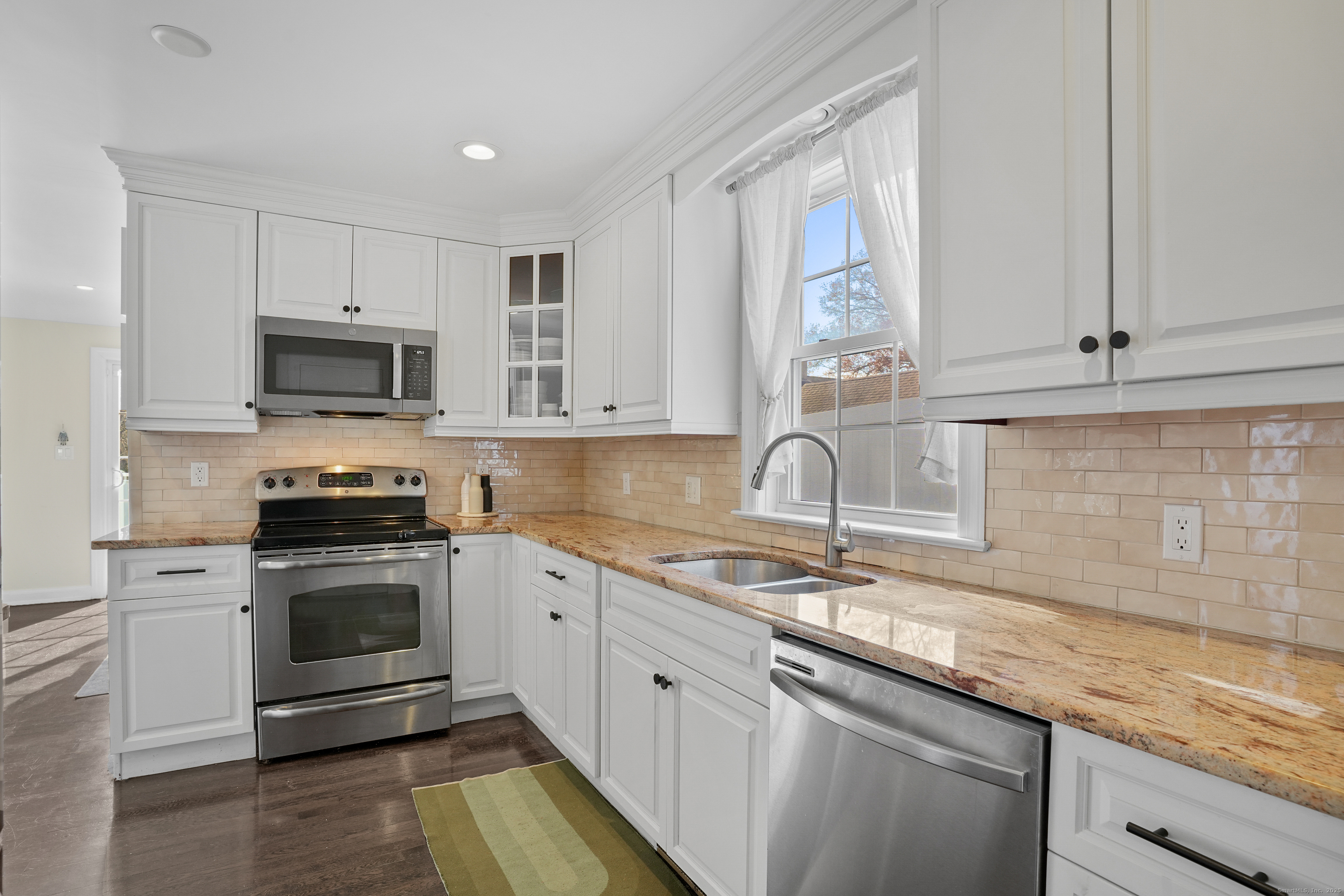 100 Hirsch Road Stamford, CT 06905 - Photo 9 of 39 a kitchen with granite countertop a stove sink and microwave