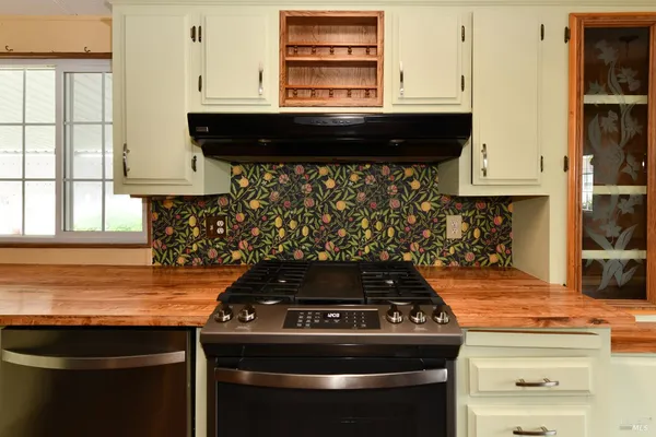 a kitchen with a sink cabinets and window
