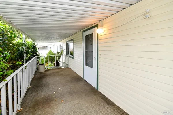 a view of a livingroom with wooden floor and a fireplace